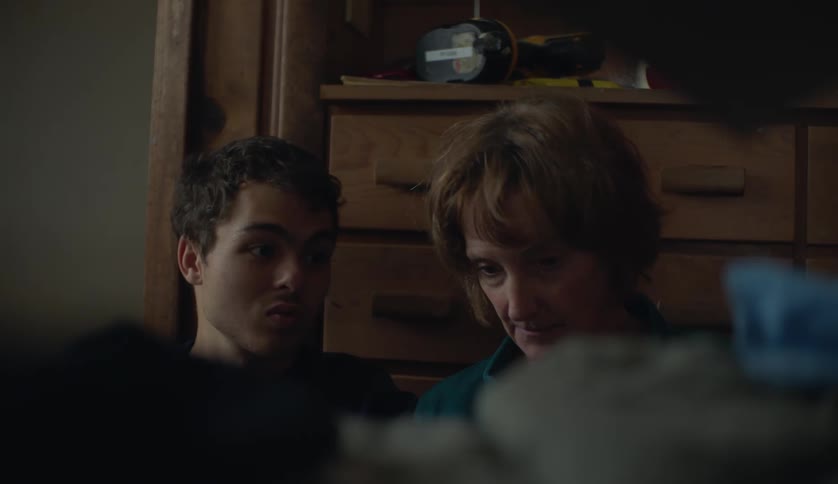 Grandmother talking with her grandson on the floor of a room at home