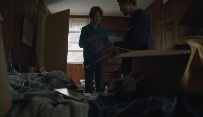 Grandmother gives instructions to her grandson while organizing a room at home
