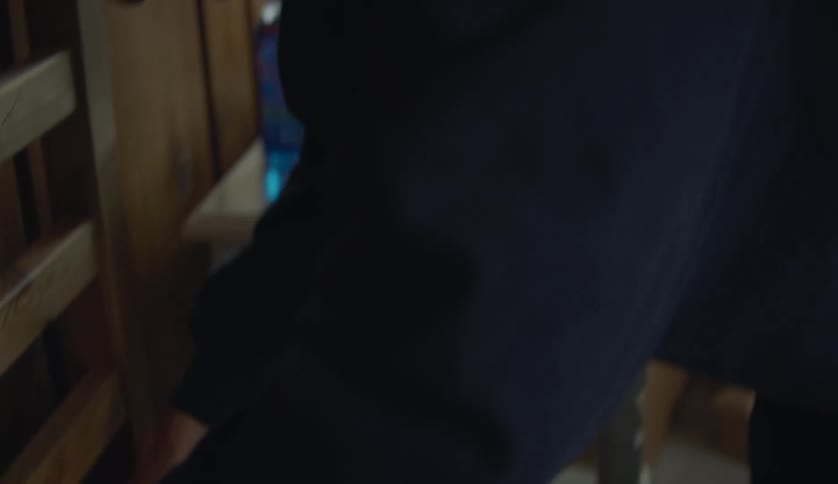 A boy is making his bed during the daytime