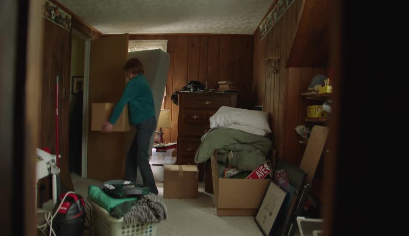 Man and middle aged woman removes boxes in room