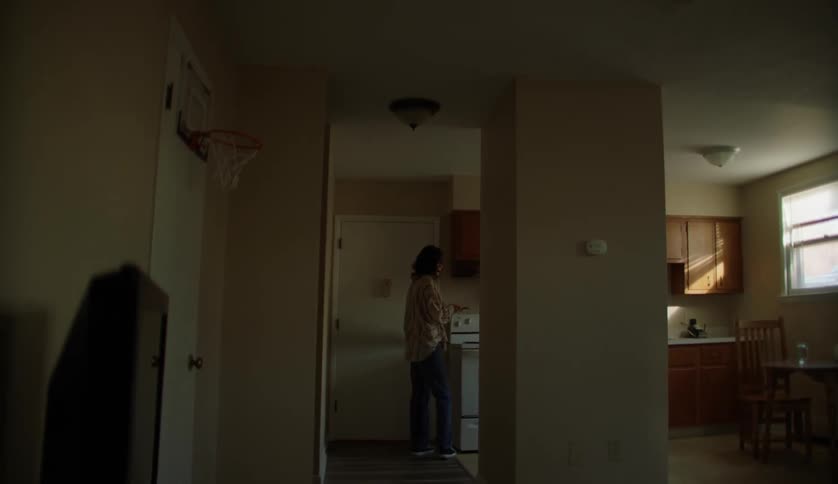 Two people are standing in a house together