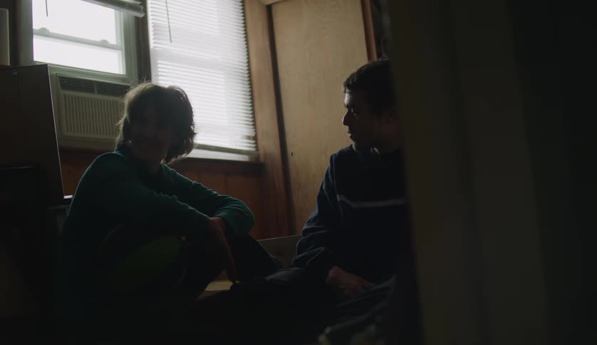 Grandmother talking with her grandson while sitting on the floor in the living room
