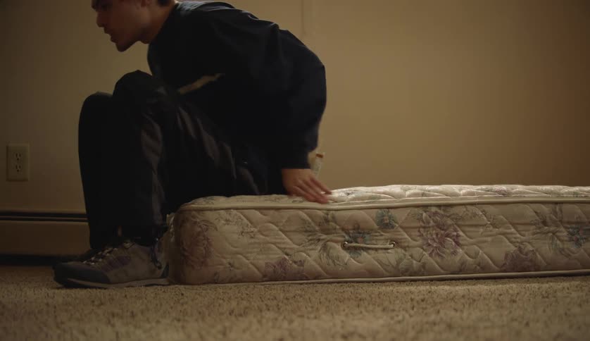 Male getting up from a mattress laying on the floor