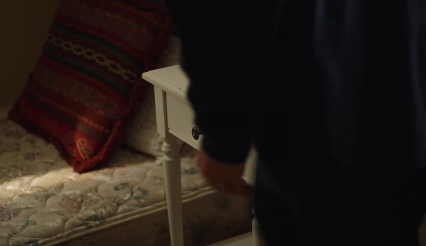 Close up of a person arranging furniture in the bedroom at home