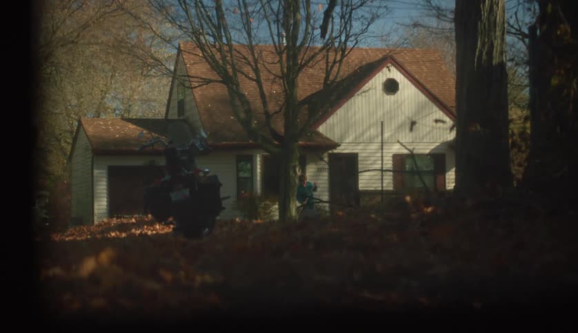 Someone is raking outdoors of there house in the day time