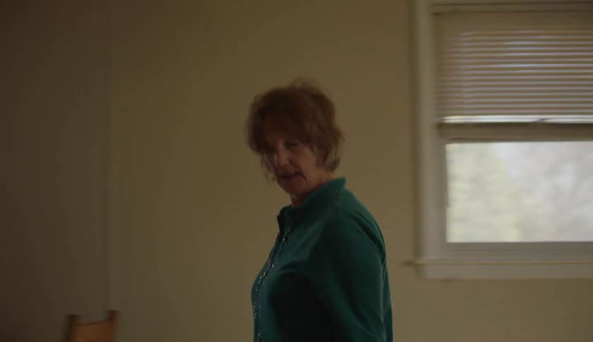 Woman looks around when walking out of a room
