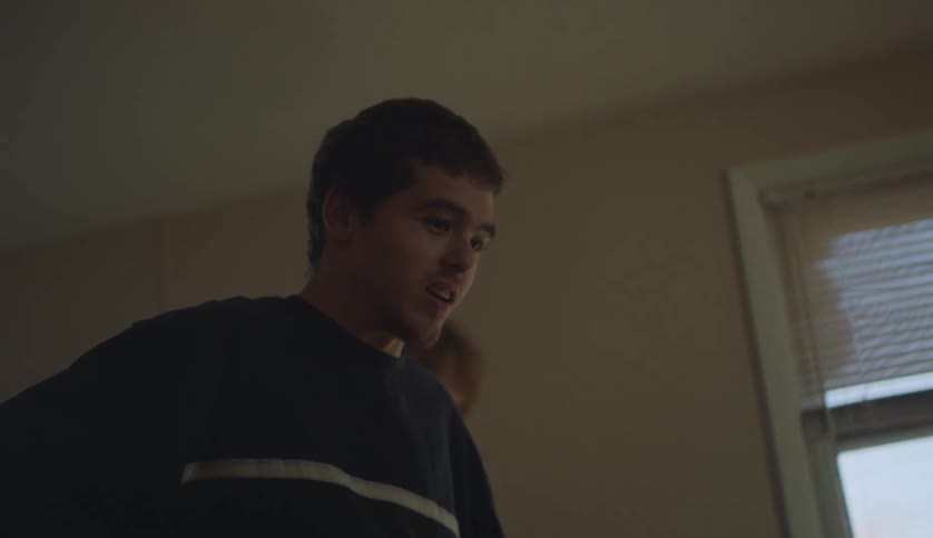 Mother and son are talking inside of their house