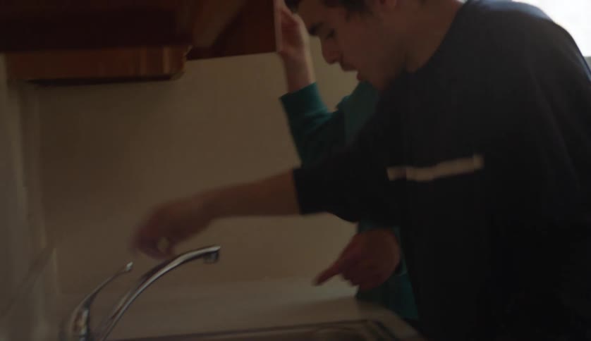 Mother and son are in their kitchen together