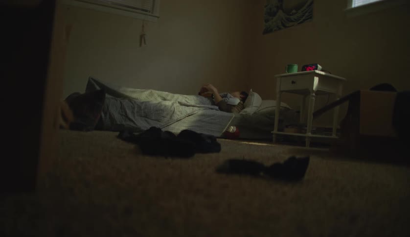 A male is laying in his bed and resting