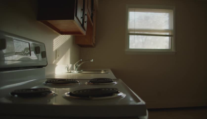 An empty kitchen in a home is displayed
