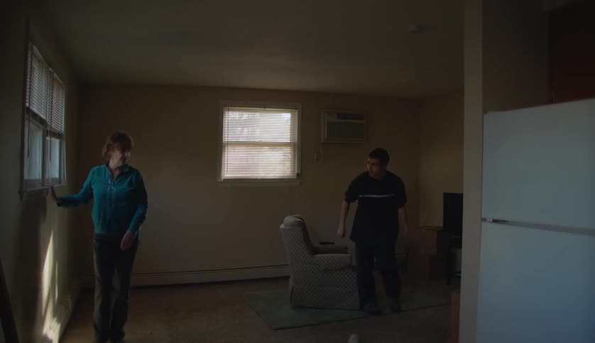 Two people are walking around their house during the day time