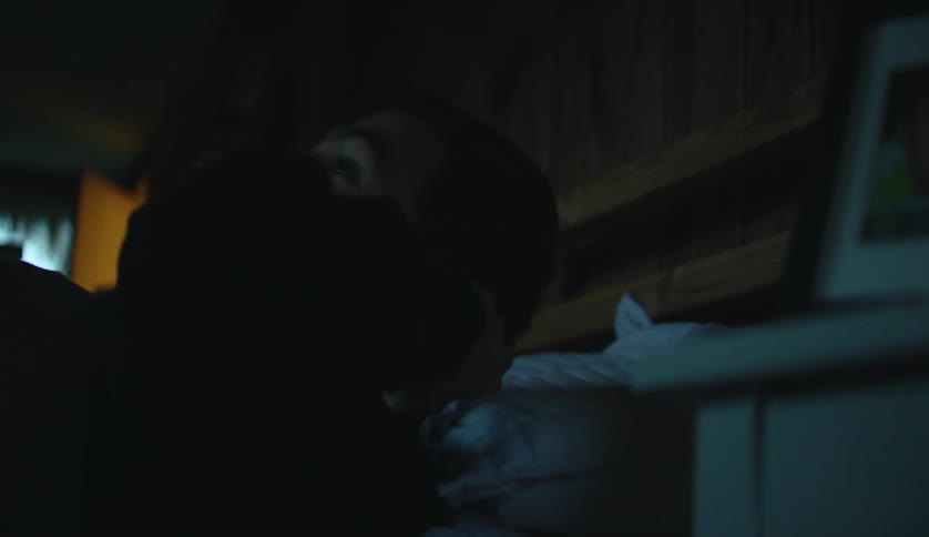 A teen is listening to music during the night time