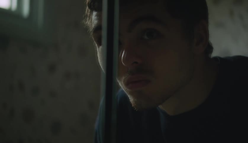 A young teenager boy is hanging out inside of his room