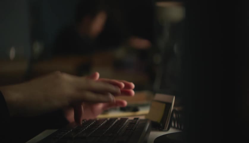 A person is pushing keys and typing with their finger on a computer keyboard