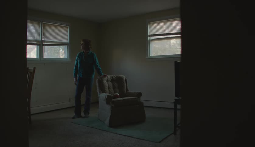 An older white woman is inside of her home in the day time