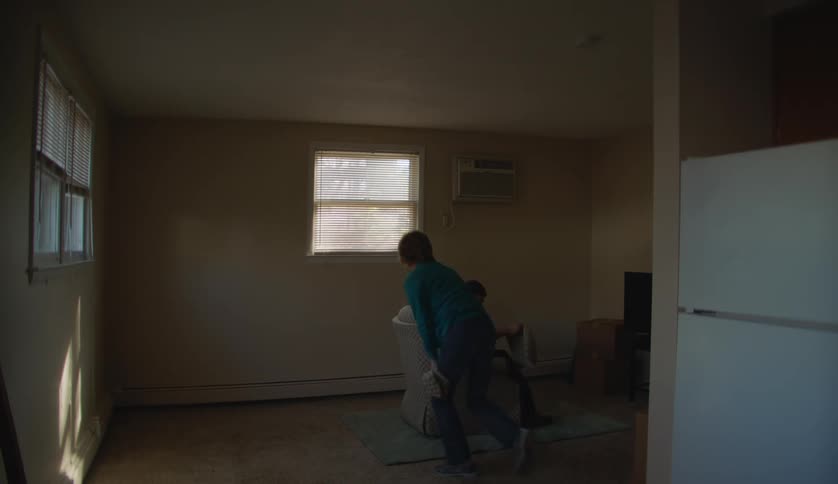 Young man with special needs assembles a chair in the living room