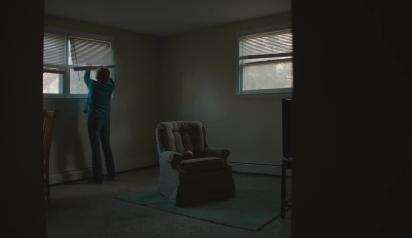 A woman is fixing the window in their house