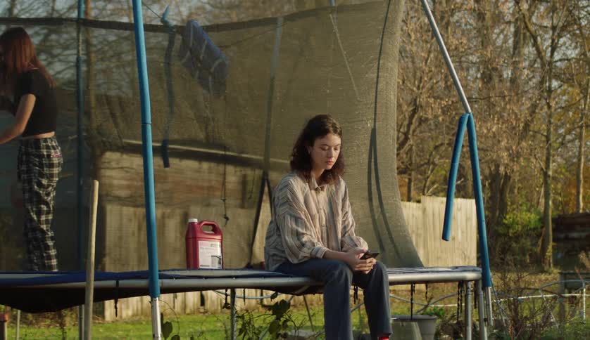 Two girls are on the trampoline