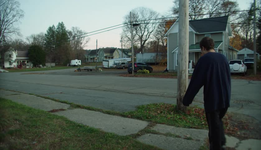 Young man with special needs walking on the neighborhood streets at morning