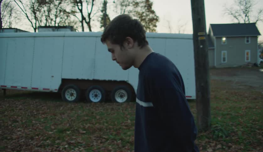 A teenager is walking past the homes