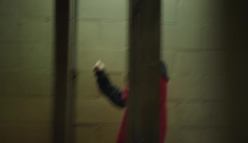Male worker at car wash interacts with other workers while walking through building