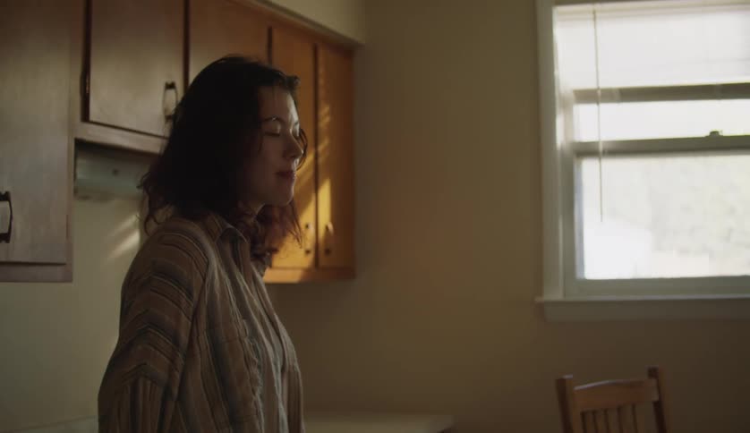 A woman smiles in the kitchen