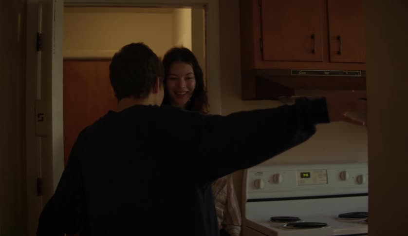 Young man with an intellectual disability opens the door for a young hip teenager at home