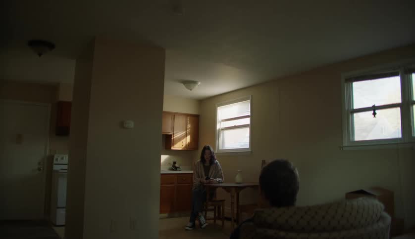 Two friends are talking in a house together
