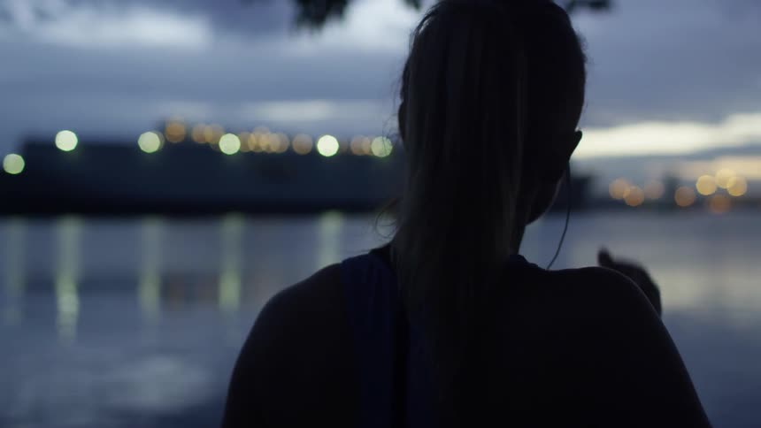 A woman puts in her earbuds