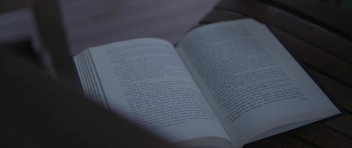 A book lays open on this table