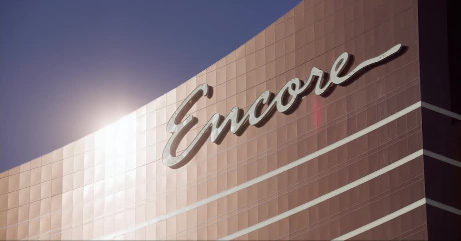 A sign on the facade of a large building on a sunny day
