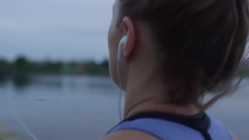 A woman jogs near a body of water
