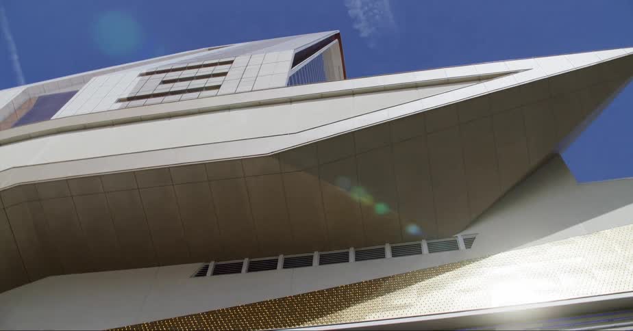 A line of shimmering lights sit above the entrance of a building