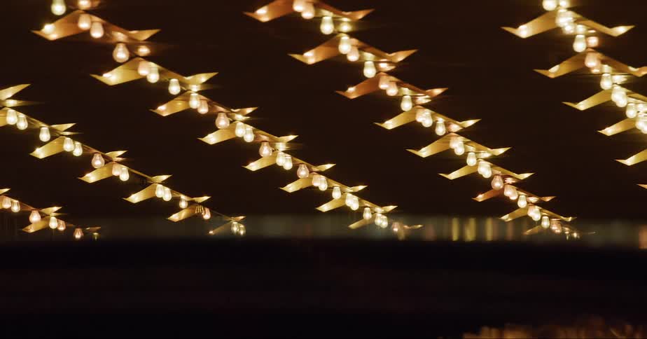 Bright lights lit up on a business as a car drives past