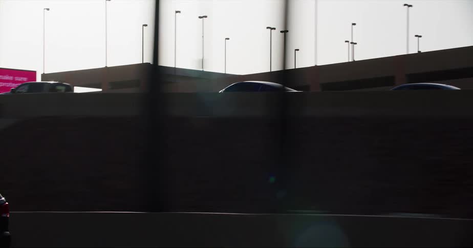 Cars are driving on a highway through a city