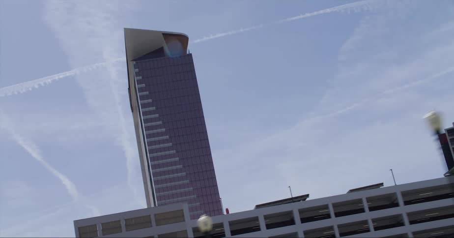A skyline of buildings with clouds in the background