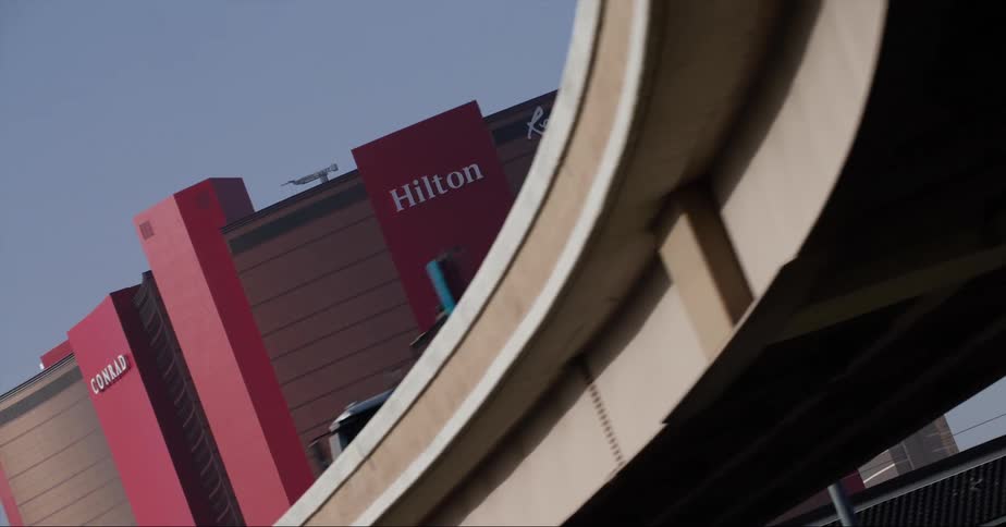 Cars driving past a hotel in a city
