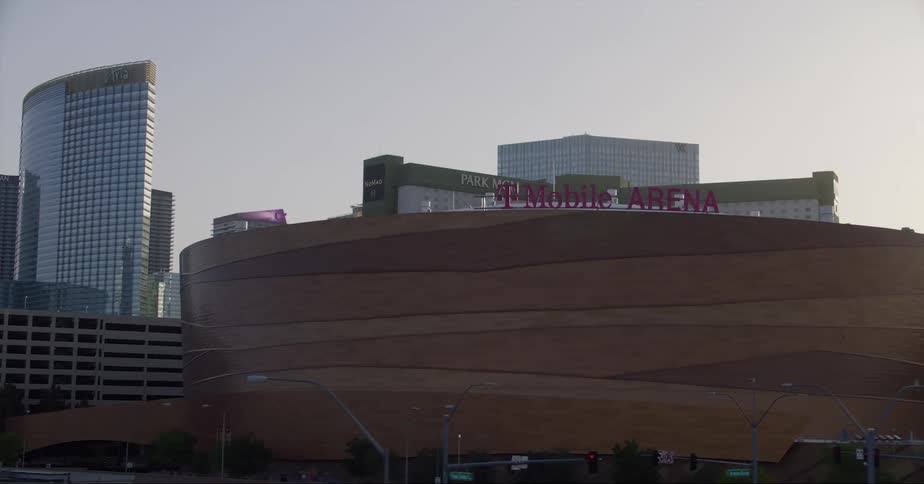 Stadium in front of the city skyline at evening seen from a moving vehicle