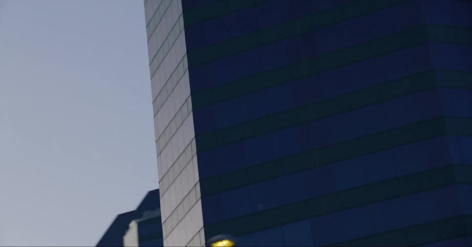 The facade of a large hotel in city during the day