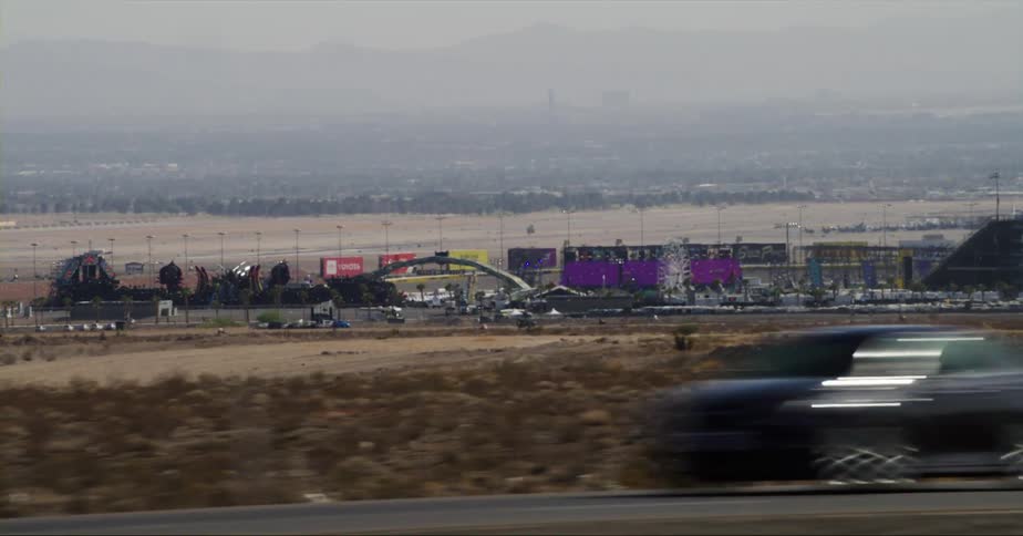 A convention center parking lot is visible from the highway