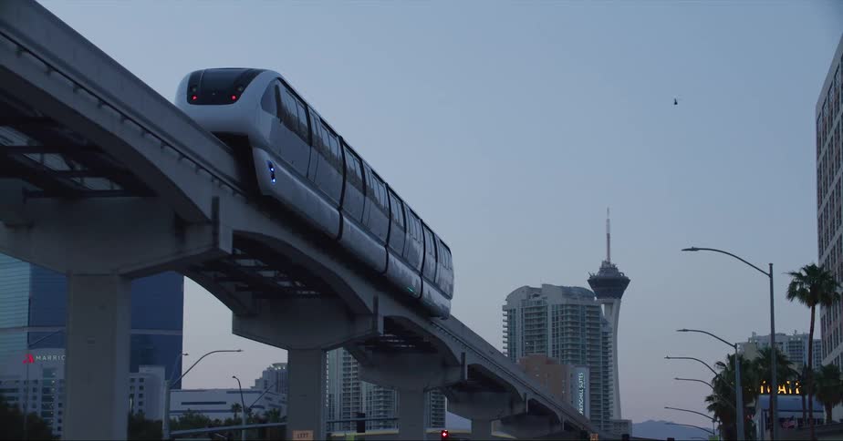 Elevated train moves along track in center of street in las vegas
