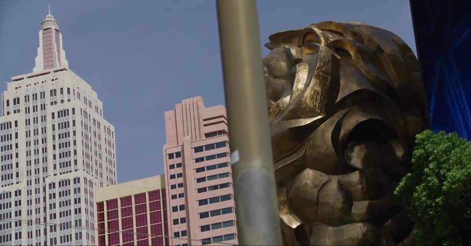 Digital sign near mgm resort lion changes pattern with skyscrapers in the background