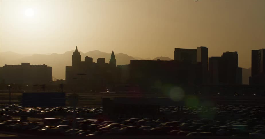 A huge parking lot is by the city