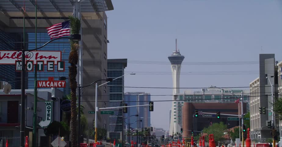 A city street with construction equipment and high rise hotels and buildings