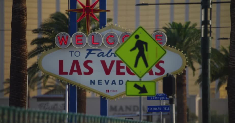 A street view of a las vegas sign and hotels