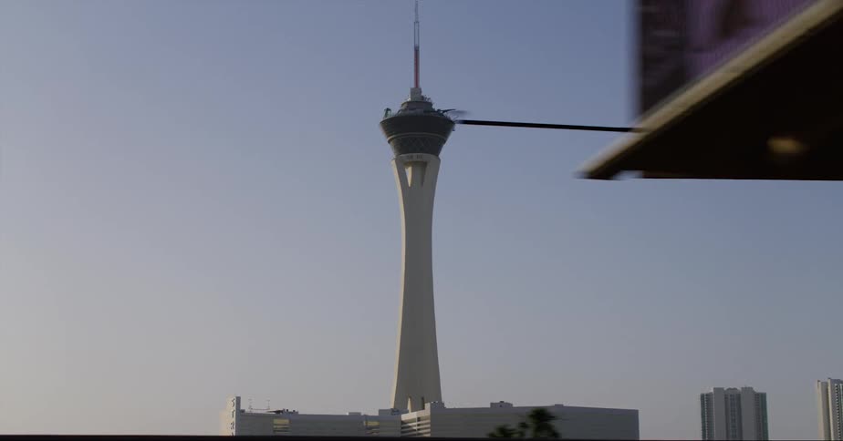 The stratosphere tower in las vegas seen from a moving vehicle at evening