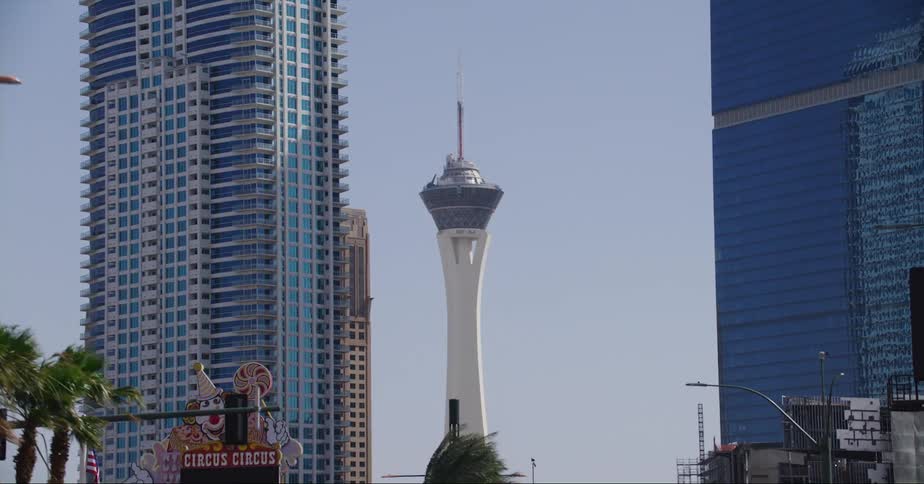 Several tall buildings and a tower are visible ahead of a road in las vegas