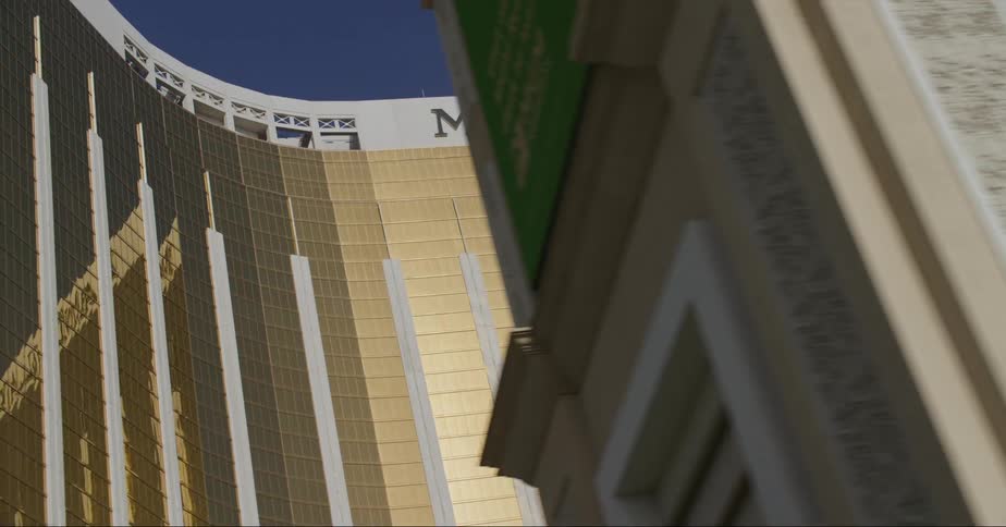 Sunlight reflects off a gold glimmering hotel and casino downtown