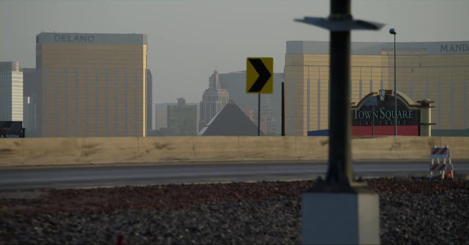 Cars are driving on a highway near a city