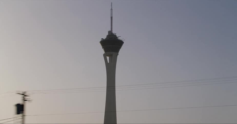A tall tower in a city with a spire